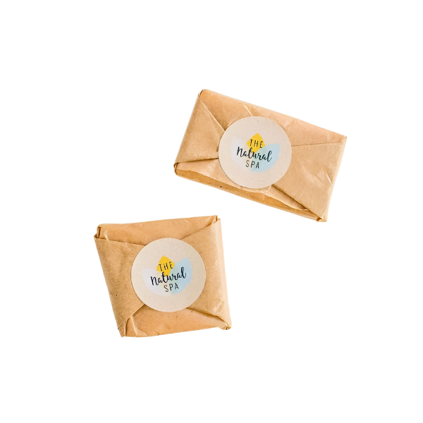 Two travel facial wash bars wrapped in paper