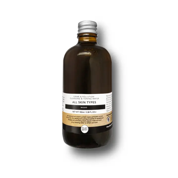 Men's micellar water and toner in dark brown glass bottle with aluminium lid on a white background