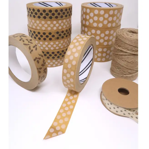 Roll of brown paper tape with white spots shown on the roll alongside other rolls and twine