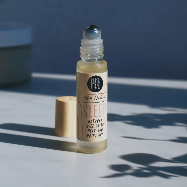 Natural pulse point roll shown with bamboo lid to the side, with text on label reading '100% natural Sleep natural roll-on to help you drift off'
