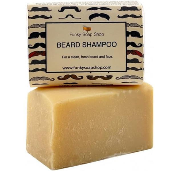 Unwrapped beard shampoo bar with a paper-wrapped bar balanced on top