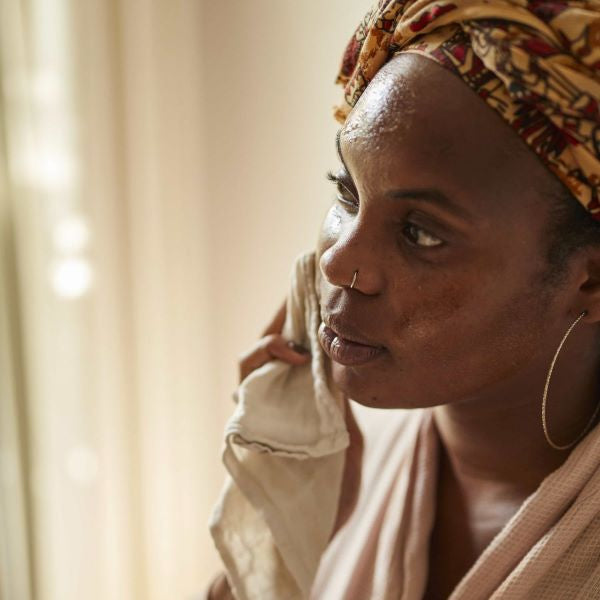 Circle cleansing balm being removed from face with muslin