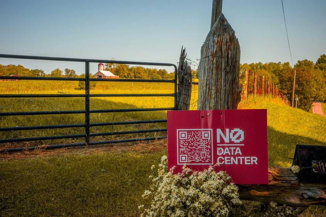 Field with trees and red sign reading 'No Data Center'. Photo by Nils Huenerfuerst on Unsplash