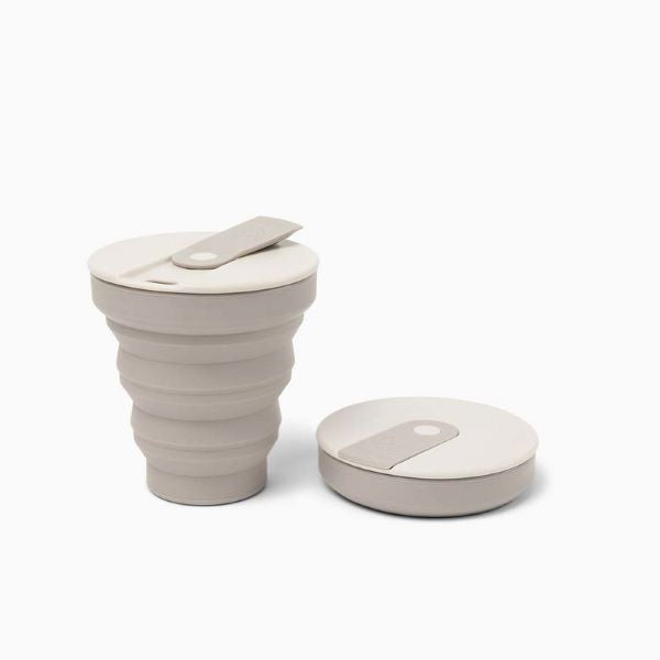 Collapsible cup shown up and collapsed in warm grey