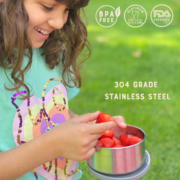Child holding a large Moonmoon storage pot with strawberries outdoors, with text reading BPA free, platinum food grade silicone, FDA approved.