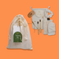 Moonie sustainable travel kit shown as cotton bag with contents alongside on orange background