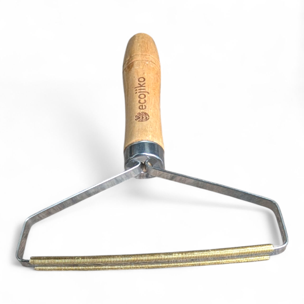 Wooden-handled metal tool lint and hair remover with 'ecoiko' branding on a white background