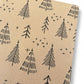 PlanetWrapIt recycled kraft wrapping paper in Christmas trees black (brown paper with printed black Christmas trees) shown close up