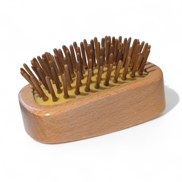 Wooden detangling hairbrush with bamboo bristles on a white background