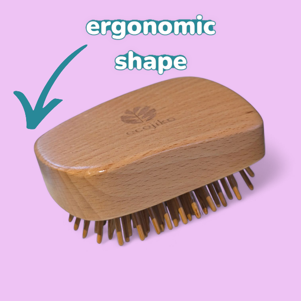 Wooden tangle teasing hairbrush with bamboo bristles on a lilac background, labelled 'ergonomic shape'.