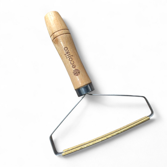 Wooden-handled metal tool lint and hair remover with 'ecoiko' branding on a white background
