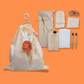 Moonie sustainable self-care with items shown alongside cotton bag on an orange background 