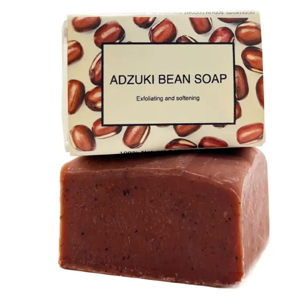 Adzuki bean soap bar in paper wrapping with text reading "Adzuki bean soap Exfoliating and softening"