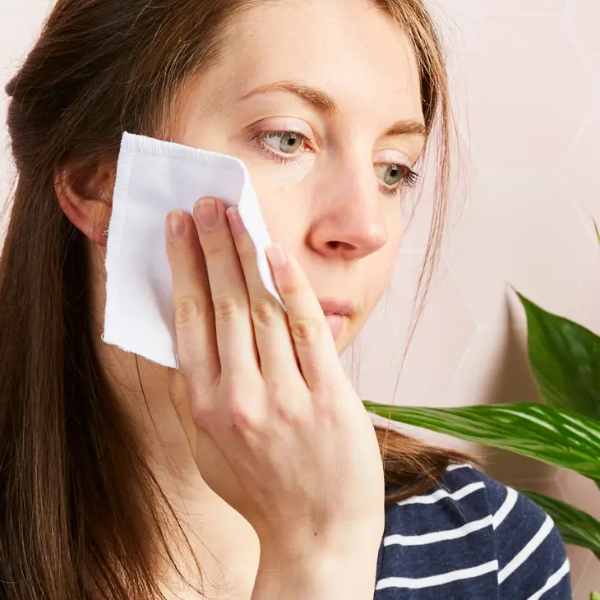 Cotton make up squares shown being wiped on a face