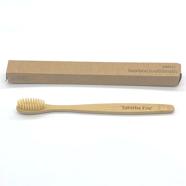 Standard bamboo toothbrush alongside cardboard box
