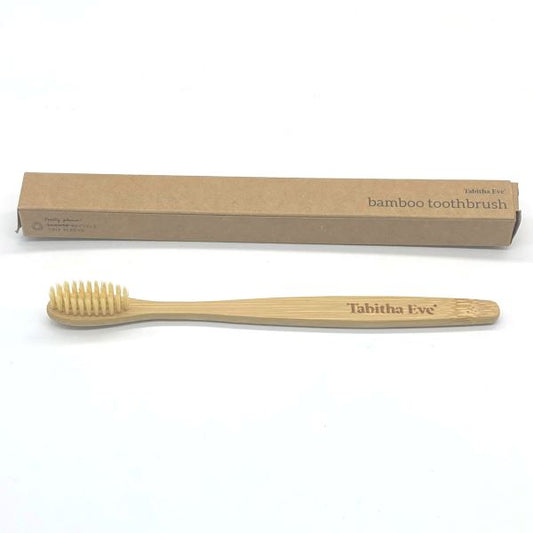 Standard bamboo toothbrush alongside cardboard box