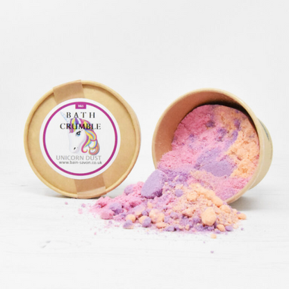 Bain and Savon bath crumble in Unicorn dust shown in paper pot with lid off and purple and orange bath crumble inside