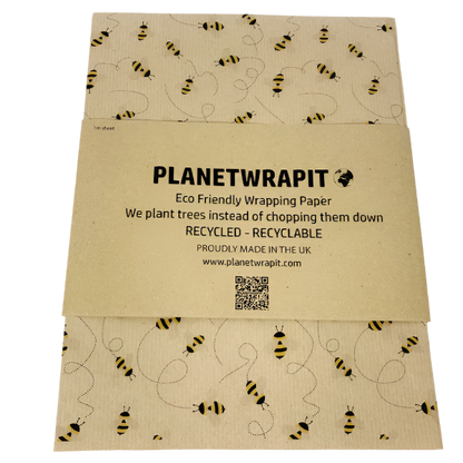Eco-friendly recyclable wrapping paper in bees design (brown paper with little bees flying around) shown as single sheet