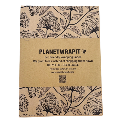 Planet Wrapit eco-friendly kraft wrapping paper with black floral design and PlanetWrapIt paper label.