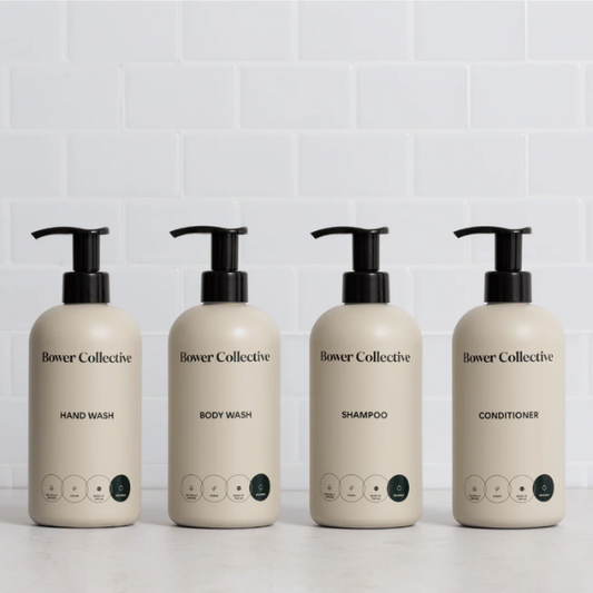 Bower Collective skincare product dispensers on a white background (hand wash, body wash, shampoo, conditioner)
