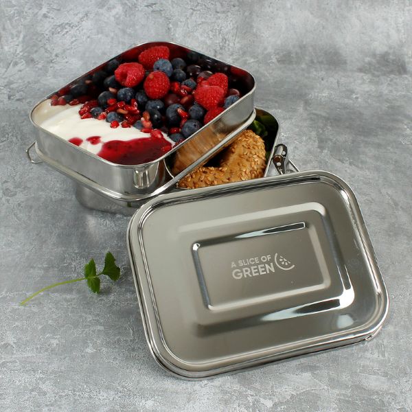 Buruni two-tier leak-resistant stainless steel lunchbox shown with yoghurt and fruit in top layer and a bagel in lower level on marble background