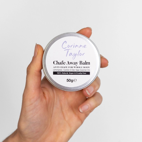 Corinne Taylor Chafe Away balm shown in a hand in aluminium tin