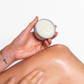 Corinne Taylor Chafe Away balm shown in a hand being applied to a leg