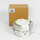 Stainless steel stackable round lunch boxes with paper wrapping on a white surface, alongside cardboard packaging.