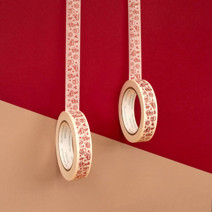 Two rolls of paper tape with a red Santa character pattern on a white background, hanging against a split red and beige background.