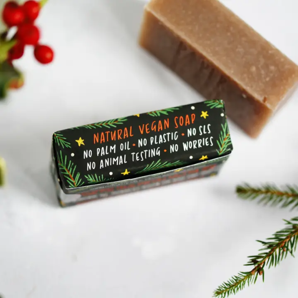 Christmas soap bars shown unwrapped and wrapped in paper with festive decoration reading natural vegan soap