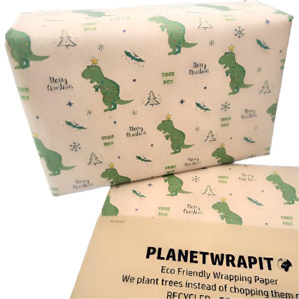 Handmade recycled Christmas wrapping paper in Christmas tree-Rex design (brown kraft paper with handdrawn-style t-rex dinosaurs and Christmas trees) shown next to a wrapped gift