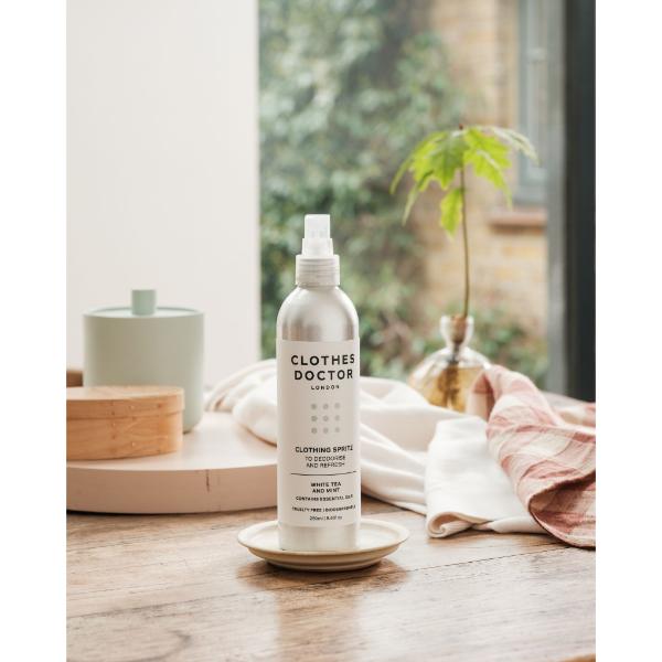 Clothes Doctor Clothing Spritz in an aluminium bottle with spray top on a wooden table