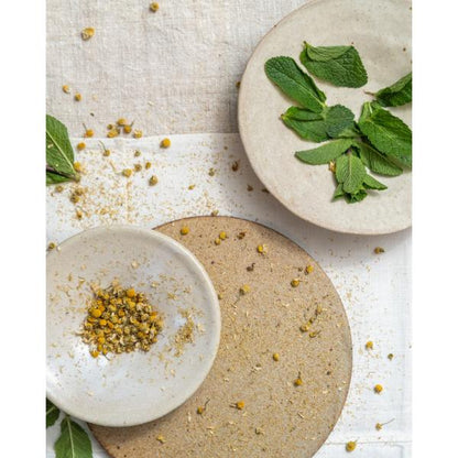 White tea and mint leaves on ceramic plates