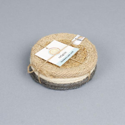 Set of 6 seagrass coasters with jute trim in natural tones tied together with twine and a paper label