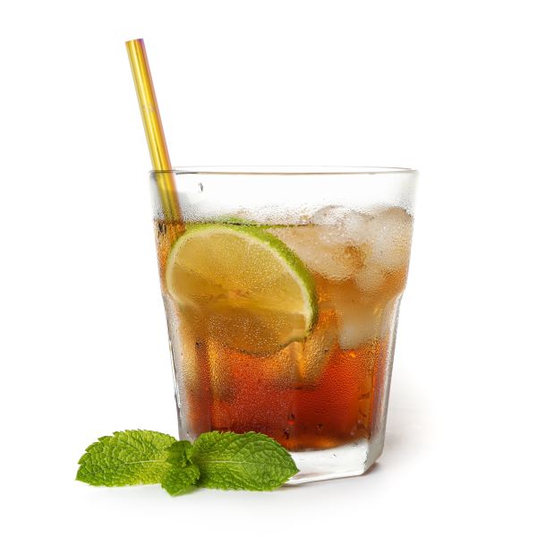 Steel cocktail straw in multicoloured rainbow inside a short glass with cocktail, ice and mint