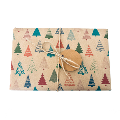 Parcel wrapped in recycled handmade wrapping paper in Colourful Christmas Trees design (brown kraft background with colourful Christmas trees in a hand-drawn style) tied with brown twine 