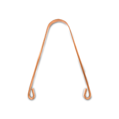 Copper tongue scraper on a white background