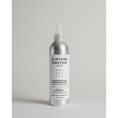 Crease release refreshing clothing spritz in aluminium bottle with spray top on a grey background