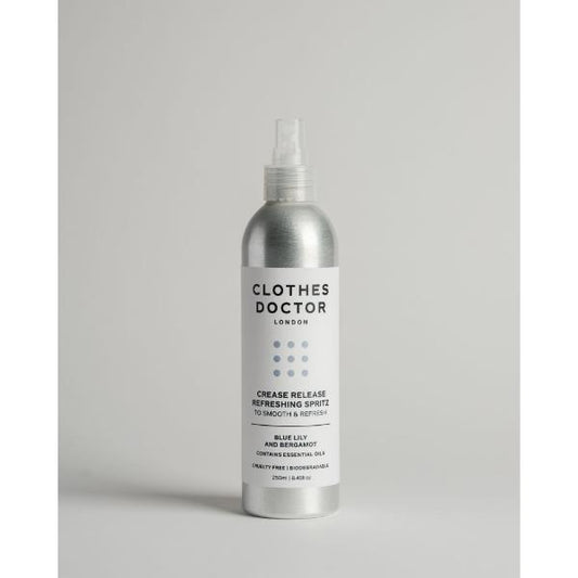 Crease release refreshing clothing spritz in aluminium bottle with spray top on a grey background