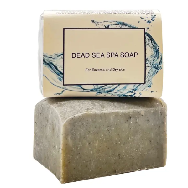 Dead Sea Soap bar shown unwrapped and wrapper in paper label with subtext reading "For eczema and dry skin"