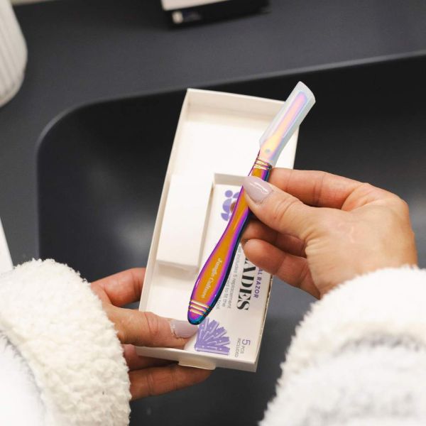 Jungle Culture's dermaplaner being taken out of cardboard packaging