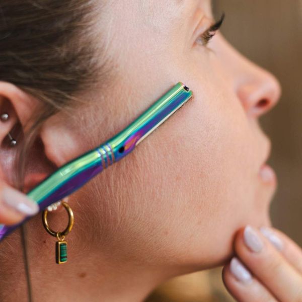 Jungle Culture's dermaplaner being used on the side of a face