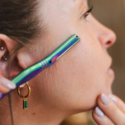 Jungle Culture's dermaplaner being used on the side of a face