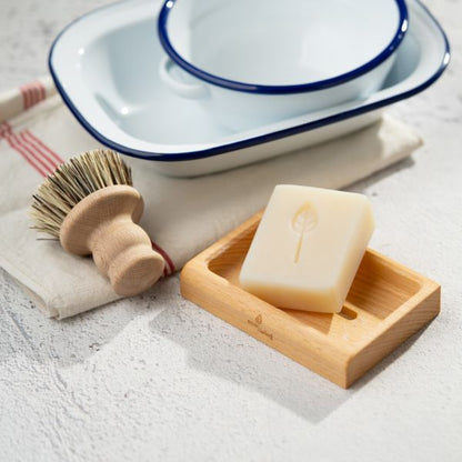 EcoLiving dish soap bar for cleaning, shown with a natural sponge, ideal for environmentally friendly kitchen dishwashing.