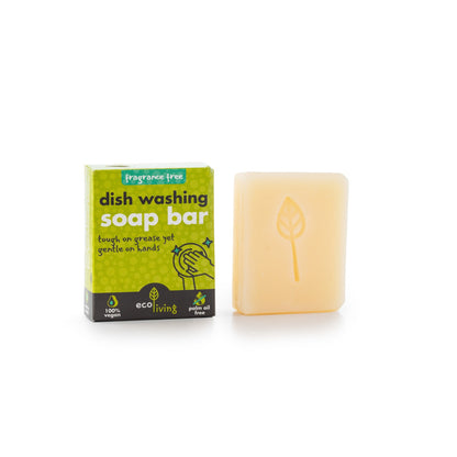 EcoLiving fragrance-free dish soap bar for eco-friendly cleaning, shown next to cleaning sponges on a kitchen countertop.
