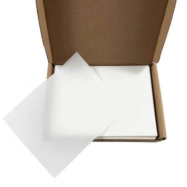 Open cardboard box with white dishwasher sheets inside
