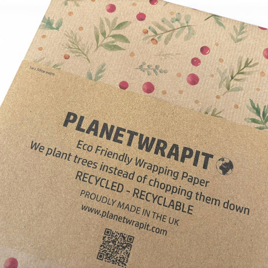PlanetWrapit kraft paper wrapping paper with a botanical pattern of green leaves and red berries, with a brown kraft paper band printed with product details.