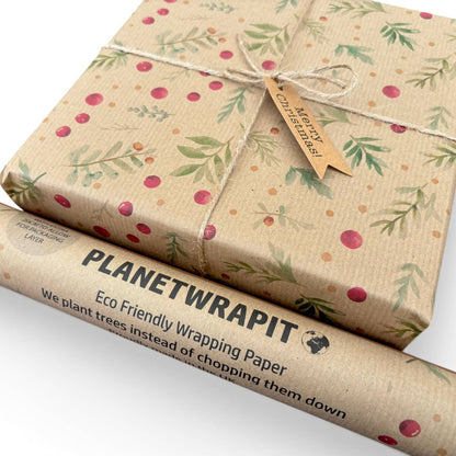 Planetwrapit Eco Friendly Wrapping Paper shown wrapped around a gift box and as a rolled tube on a white background. The wrapping paper has a natural kraft paper texture with a pattern of green leaves and red berries.