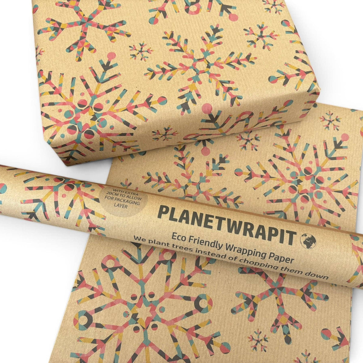 Planetwrapit eco-friendly wrapping paper in a kraft brown colour, decorated with colourful snowflake patterns and shown as a roll, sheet and wrapped gift boxes on a white background.