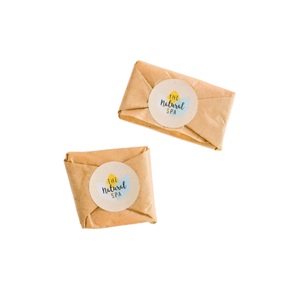 Two travel facial wash bars wrapped in paper